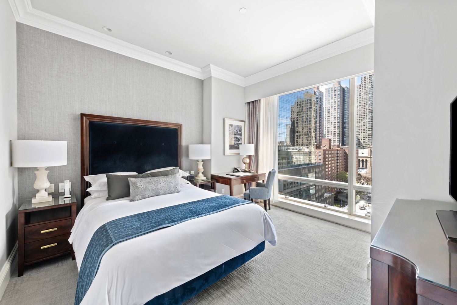 Bedroom with a wide window and city views at 1 Central Park West